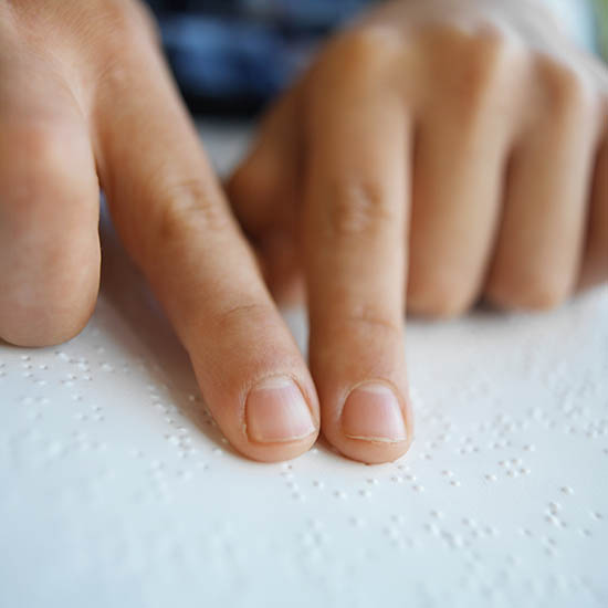 Two fingers reading braille