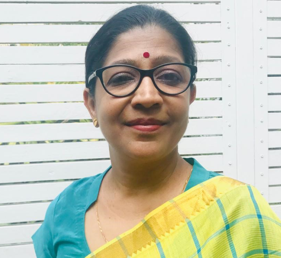 A photo of Vani Seshadri, an Indian woman wearing turquoise and yellow